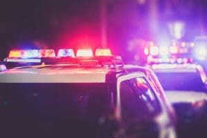 a close up of a police car with its lights on.