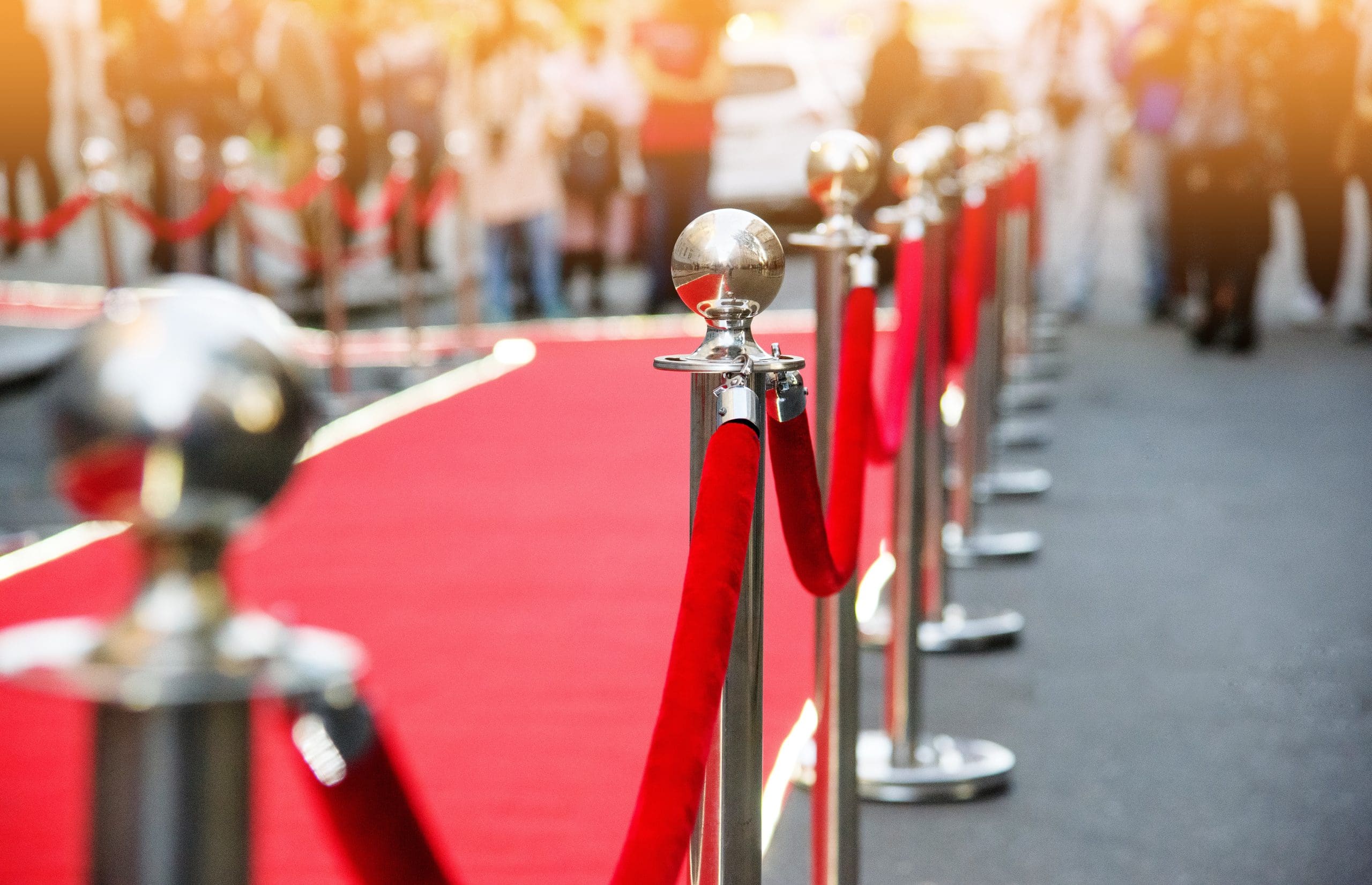 A red carpet with people walking along it.